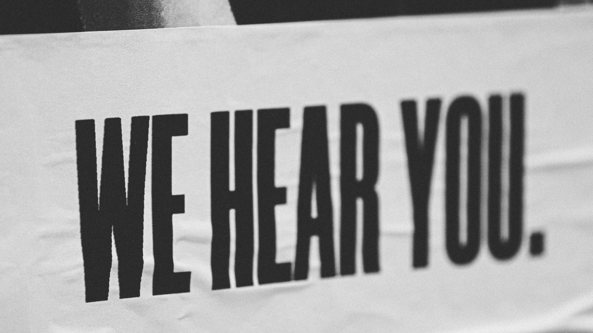 Poster showing the words 'We Hear You'